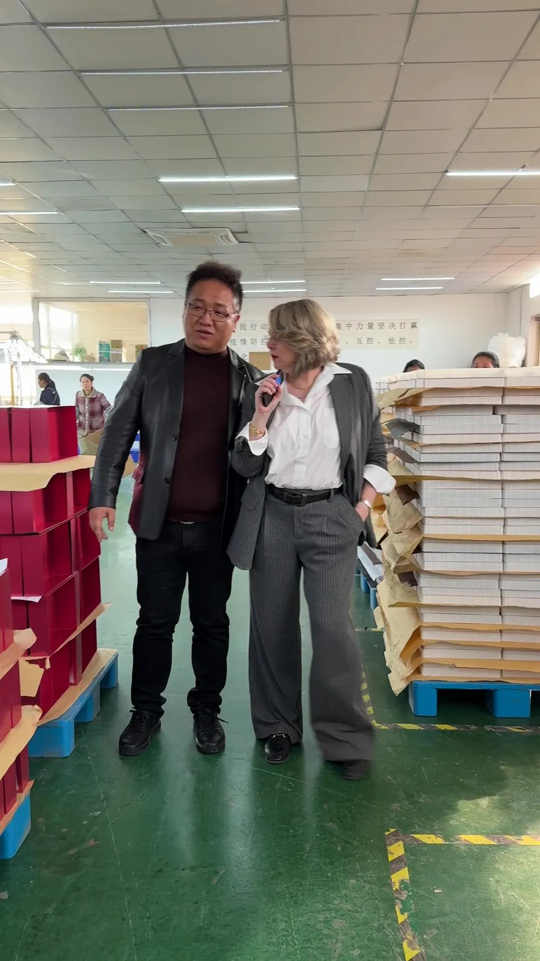 Max Dai with international client at packaging factory